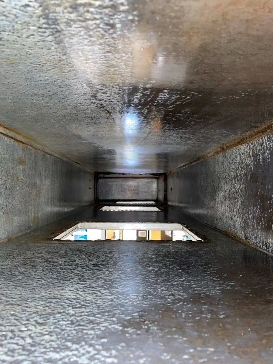 Inside view of commercial kitchen ductwork after professional TR19 cleaning — surfaces fully cleaned and compliant
